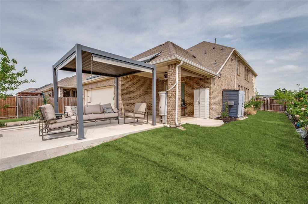6117 Hall Road Frisco, TX 75034 - Photo 27 of 32 Rear view of house with a fenced backyard, brick siding, a patio area, and a shingled roof