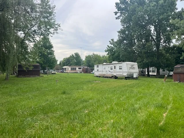 a view of house with backyard