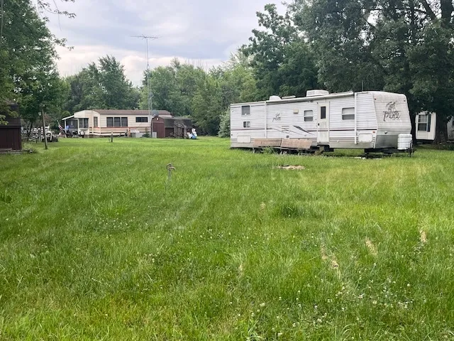 a view of a house with a small yard and sitting area