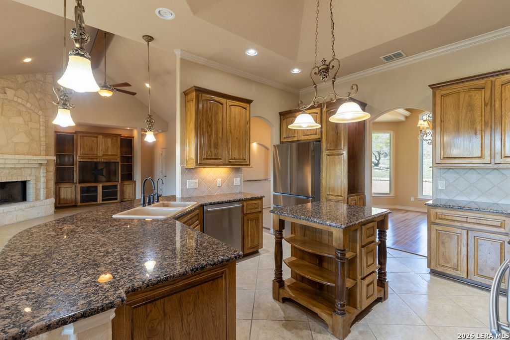198 Echo Falls Road Comfort, TX 78013 - Photo 11 of 25 a kitchen with stainless steel appliances granite countertop a stove and a sink