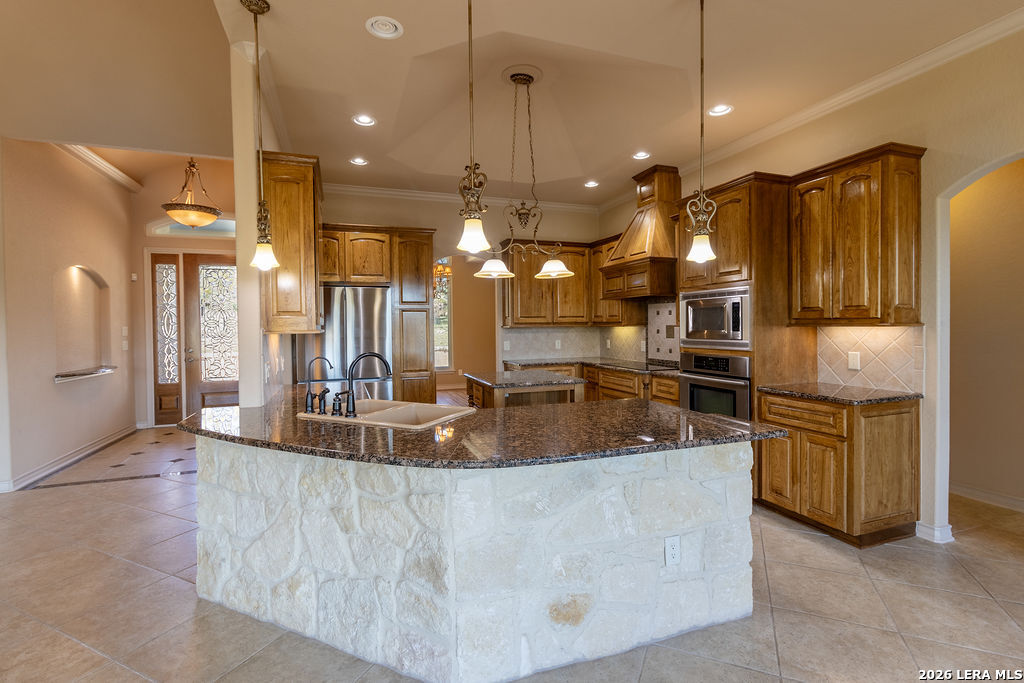 198 Echo Falls Road Comfort, TX 78013 - Photo 12 of 25 a kitchen with stainless steel appliances granite countertop a sink a oven a refrigerator and a stove