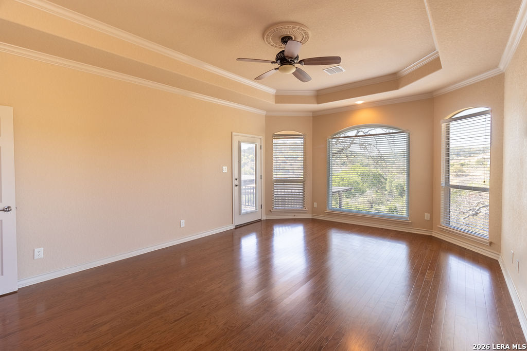 198 Echo Falls Road Comfort, TX 78013 - Photo 14 of 25 a view of an empty room with wooden floor and a window