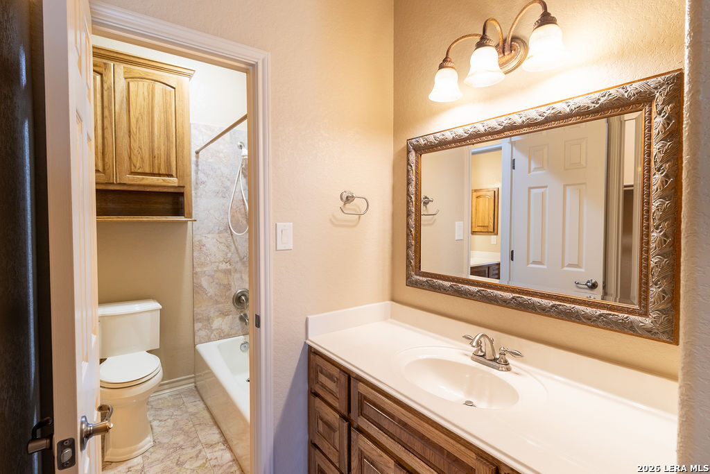 198 Echo Falls Road Comfort, TX 78013 - Photo 18 of 25 a bathroom with a sink a toilet and a mirror
