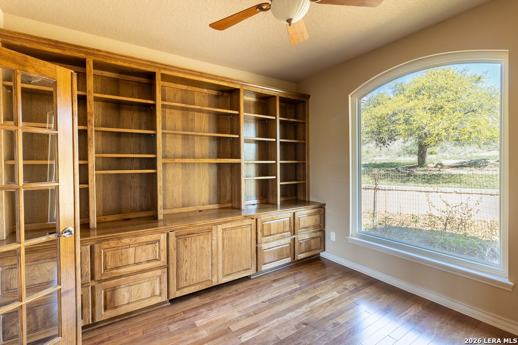 198 Echo Falls Road Comfort, TX 78013 - Photo 21 of 25 a view of an empty room with a window and wooden floor