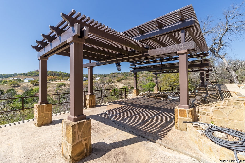 198 Echo Falls Road Comfort, TX 78013 - Photo 23 of 25 a view of a patio with a table chairs and a glass door