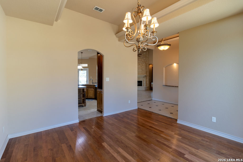198 Echo Falls Road Comfort, TX 78013 - Photo 6 of 25 a view of a hallway with wooden floor and chandelier