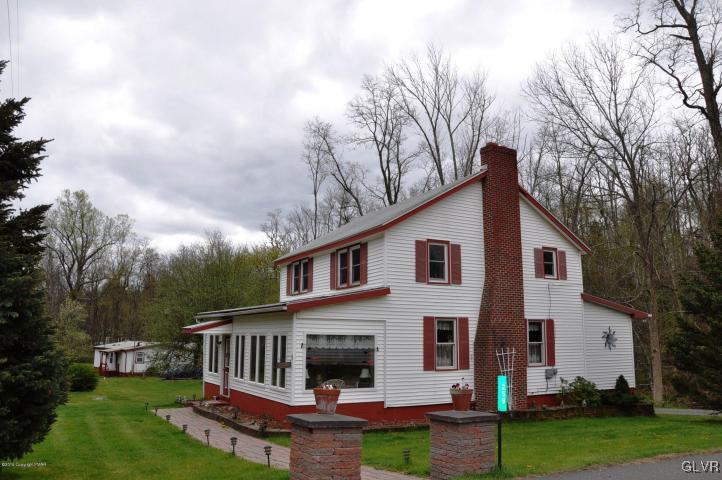 259 Wieboldt Road Cresco, PA 18326 - Photo 2 of 16 a view of house with a big yard plants and large trees