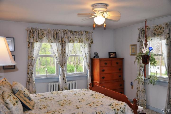 259 Wieboldt Road Cresco, PA 18326 - Photo 3 of 16 a bedroom with a bed dresser and a window