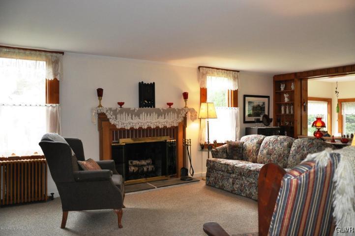 259 Wieboldt Road Cresco, PA 18326 - Photo 4 of 16 a living room with furniture and a fireplace