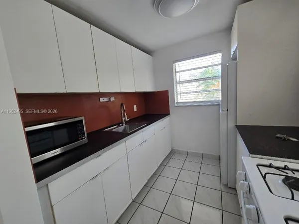 a kitchen with stainless steel appliances a stove a microwave and a counter top