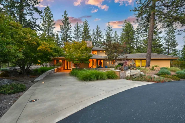 a front view of a house with a yard and a garage