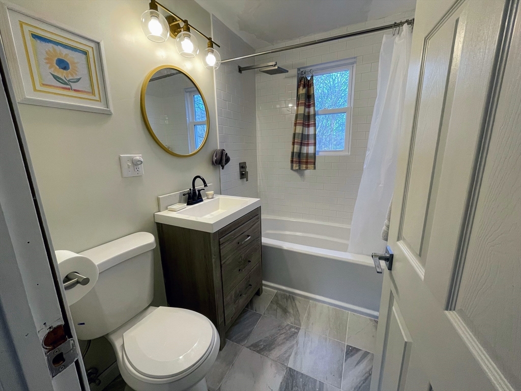 8 Pike Street Hopkinton, MA 01748 - Photo 15 of 34 a bathroom with a sink a toilet and a mirror