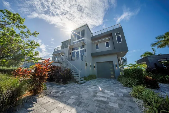 a view of a house with a yard and plants