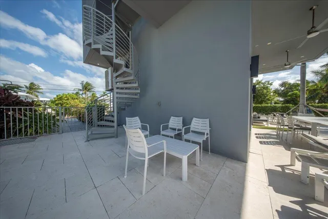 a living room with furniture a flat screen tv and a table