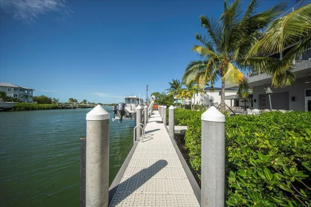 a spacious bedroom with a bed and a chandelier