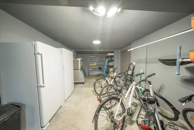 a spacious bedroom with a bed and a wooden floor