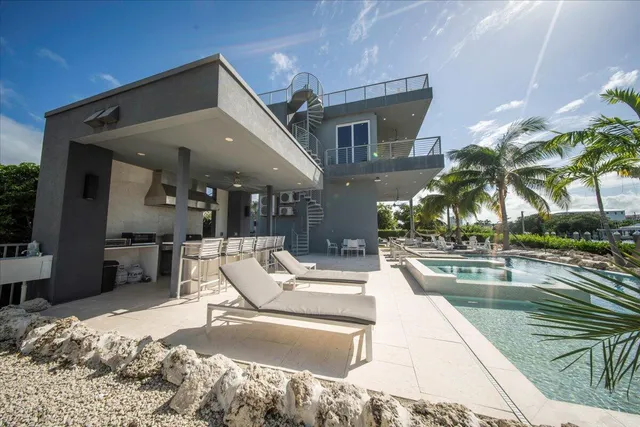 a view of a house with a yard and sitting area