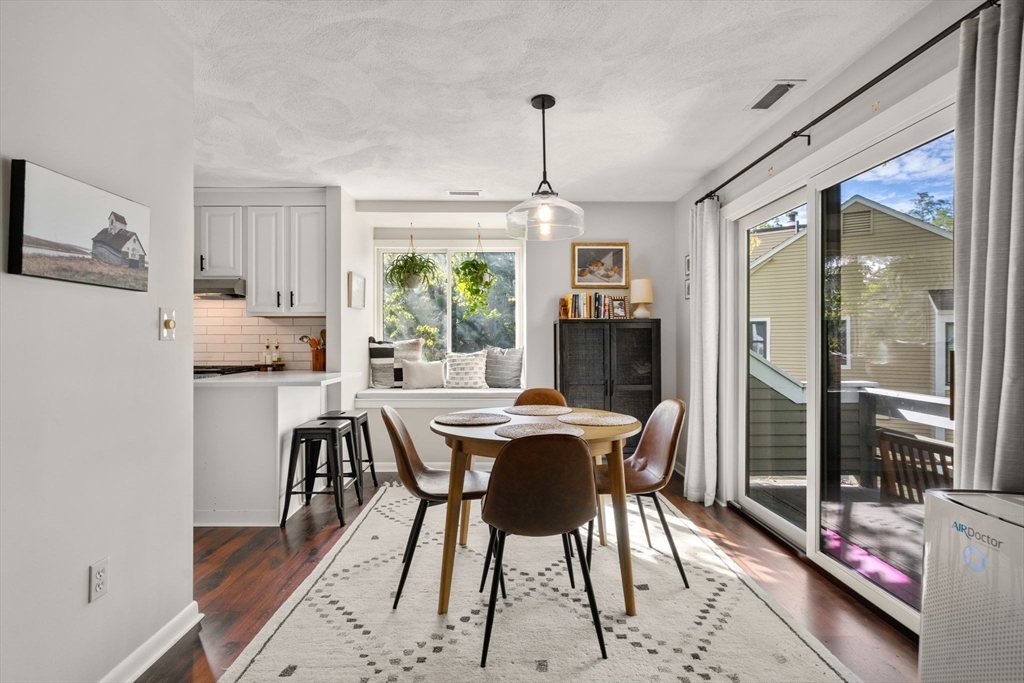 22 Concord Greene, Unit 2 Concord, MA 01742 - Photo 16 of 36 a dining room with furniture a chandelier and wooden floor