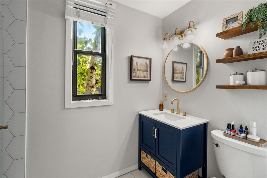 22 Concord Greene, Unit 2 Concord, MA 01742 - Photo 22 of 36 a bathroom with a toilet a sink and a mirror