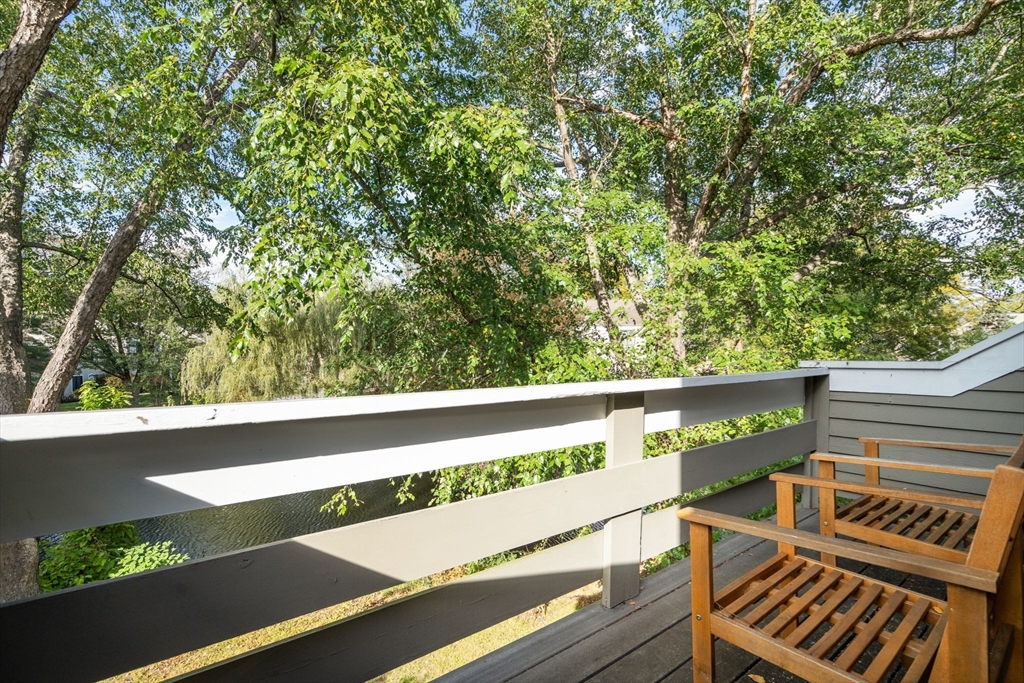 22 Concord Greene, Unit 2 Concord, MA 01742 - Photo 26 of 36 a view of a balcony with wooden floor and fence