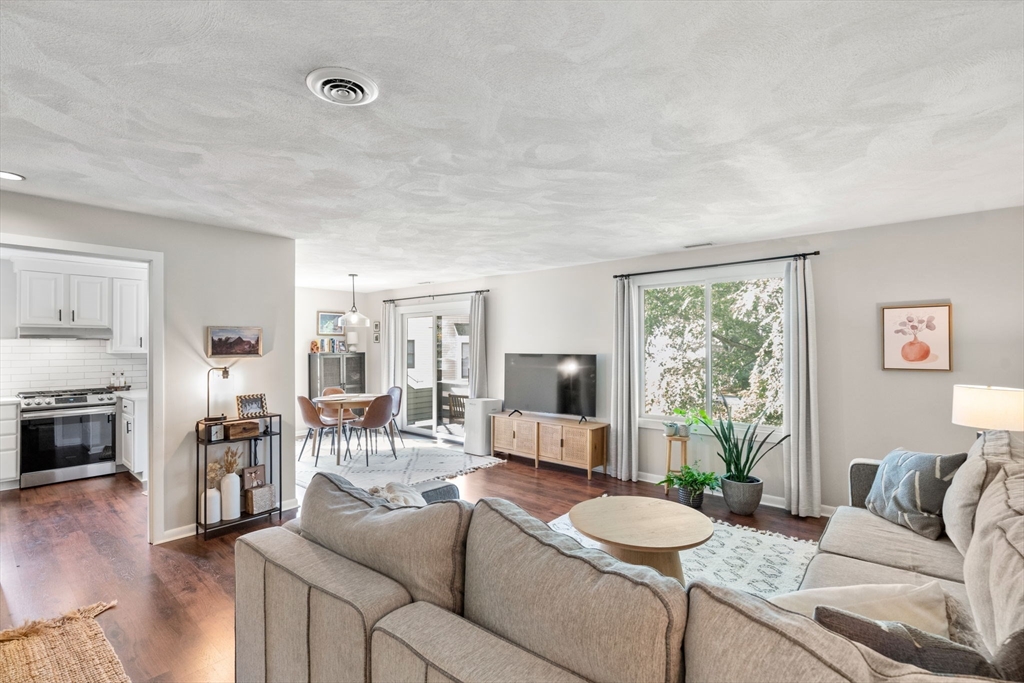 22 Concord Greene, Unit 2 Concord, MA 01742 - Photo 3 of 36 a living room with furniture and a floor to ceiling window