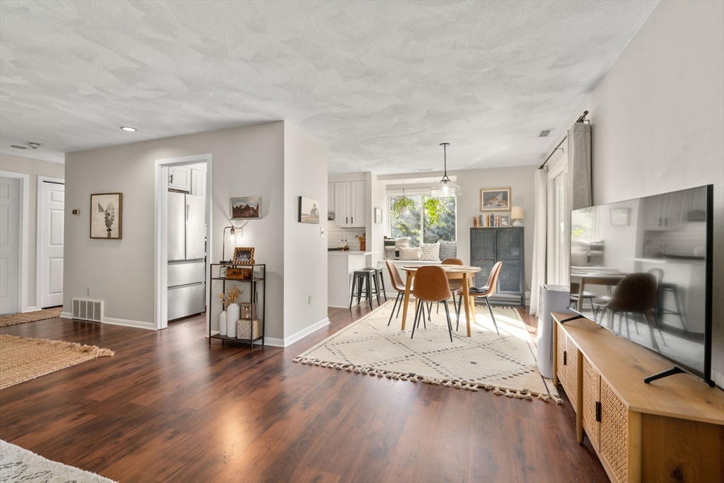 22 Concord Greene, Unit 2 Concord, MA 01742 - Photo 4 of 36 a living room with furniture wooden floor and a flat screen tv