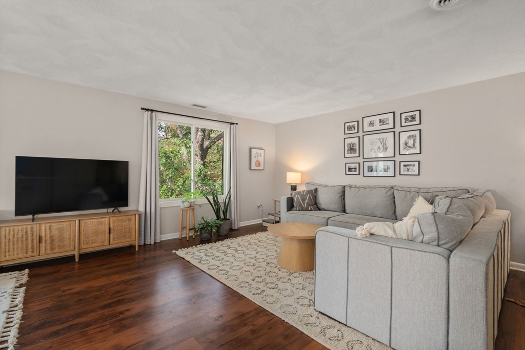 22 Concord Greene, Unit 2 Concord, MA 01742 - Photo 9 of 36 a living room with furniture and a flat screen tv