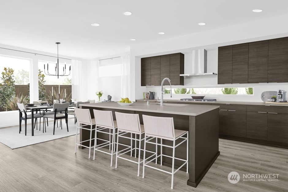 3931 198th Place Southeast Bothell, WA 98012 - Photo 9 of 14 a kitchen with a dining table chairs sink and cabinets