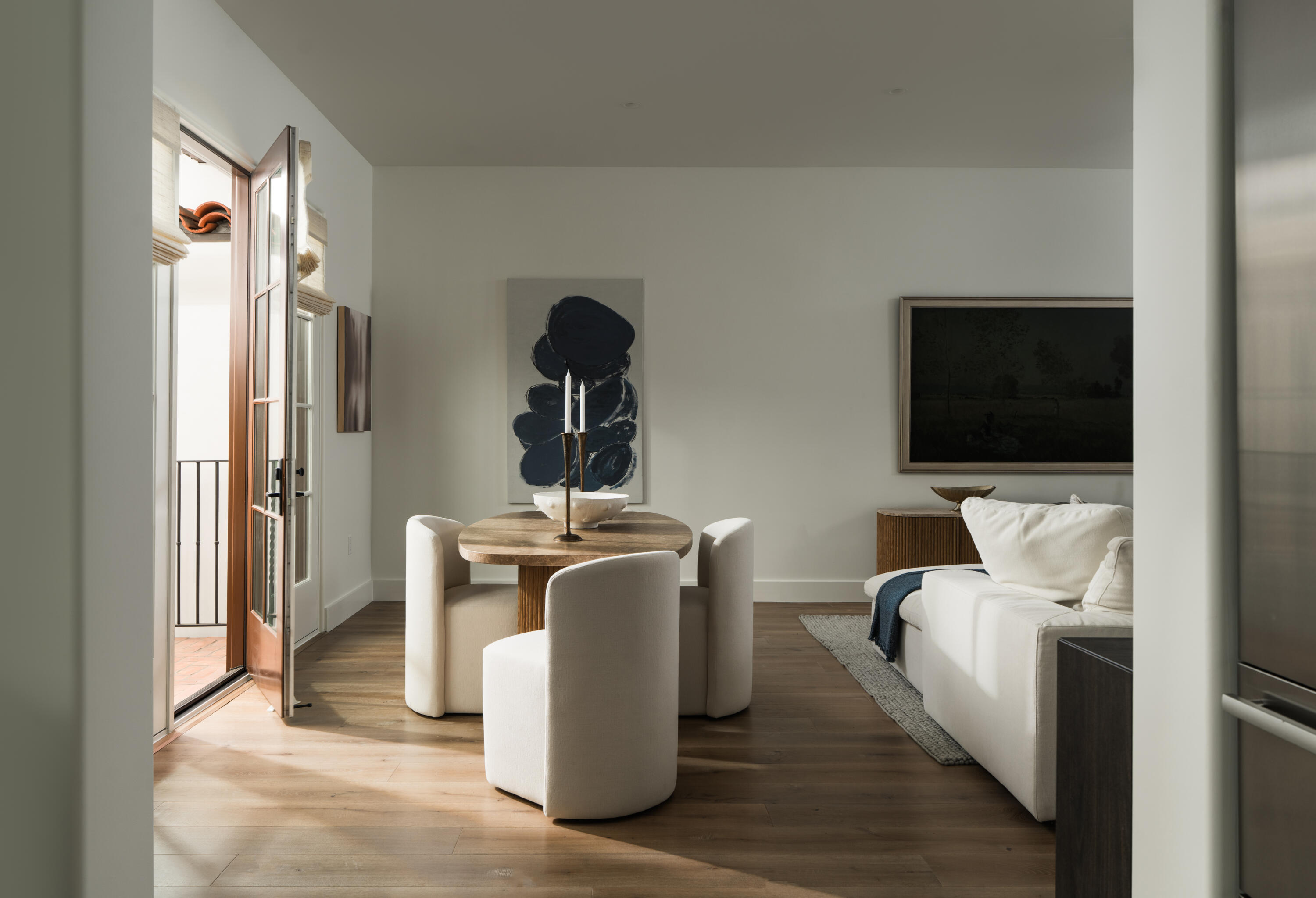 18 West Victoria Street, Unit 206 Santa Barbara, CA 93101 - Photo 5 of 18 a living room with a couch and a flat screen tv