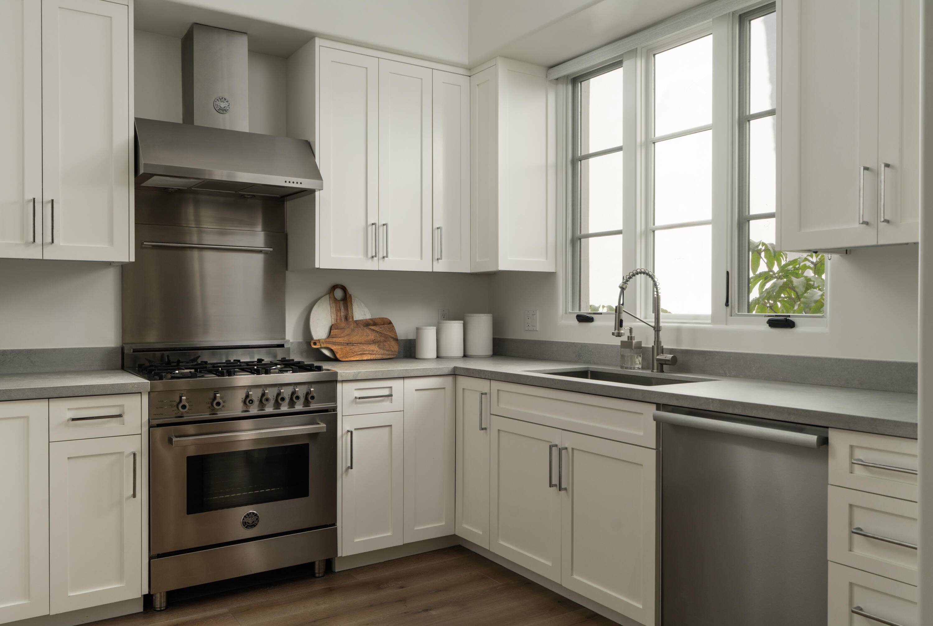 18 West Victoria Street, Unit 206 Santa Barbara, CA 93101 - Photo 6 of 18 a kitchen with cabinets appliances a sink and a window