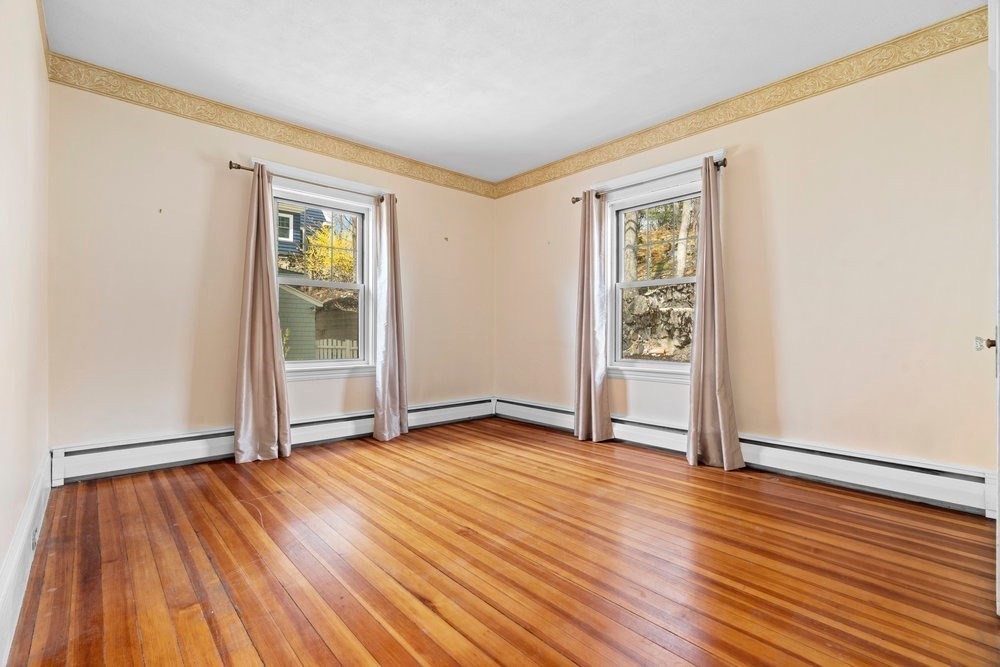 33 Nowell Road Melrose, MA 02176 - Photo 19 of 35 an empty room with wooden floor and windows