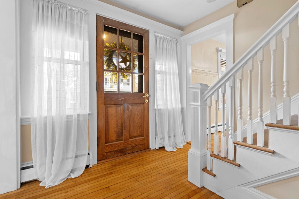 33 Nowell Road Melrose, MA 02176 - Photo 4 of 35 a view of a bedroom with wooden floor and windows