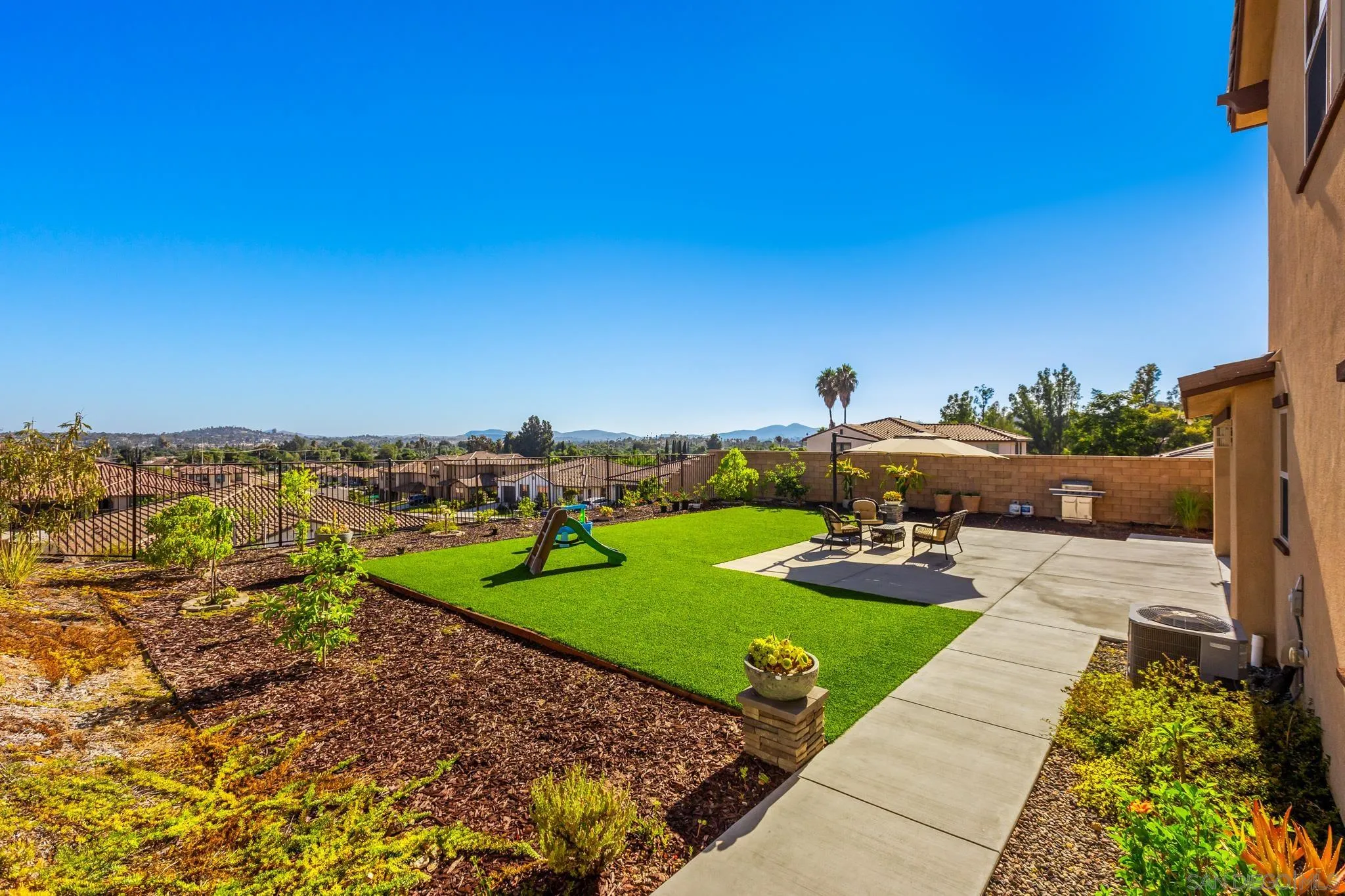2401 Monroe Place Escondido, CA 92027 - Photo 2 of 23 a view of a backyard with plants and outdoor seating