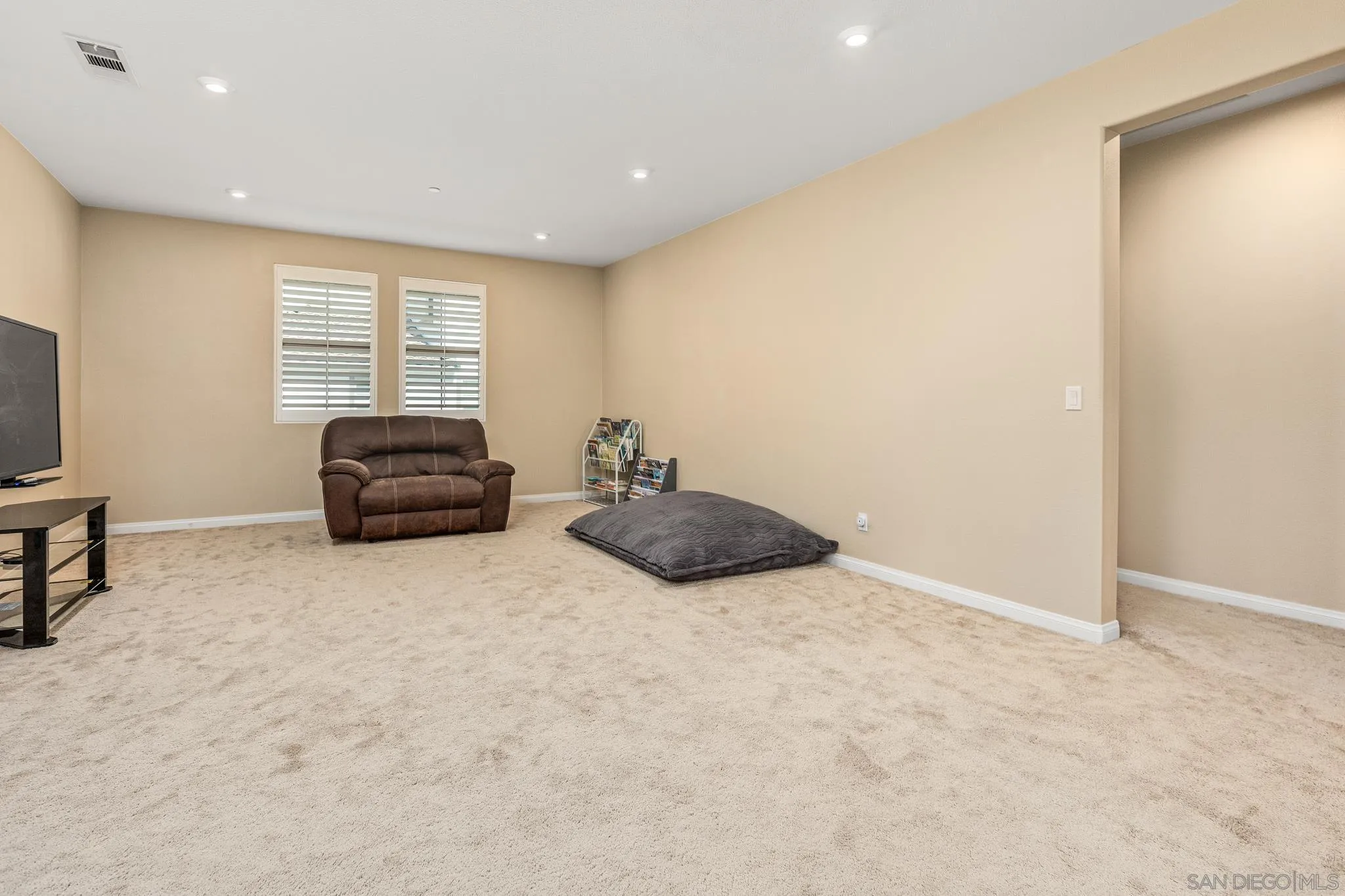 2401 Monroe Place Escondido, CA 92027 - Photo 21 of 23 a living room with furniture a air conditioner vent and a window
