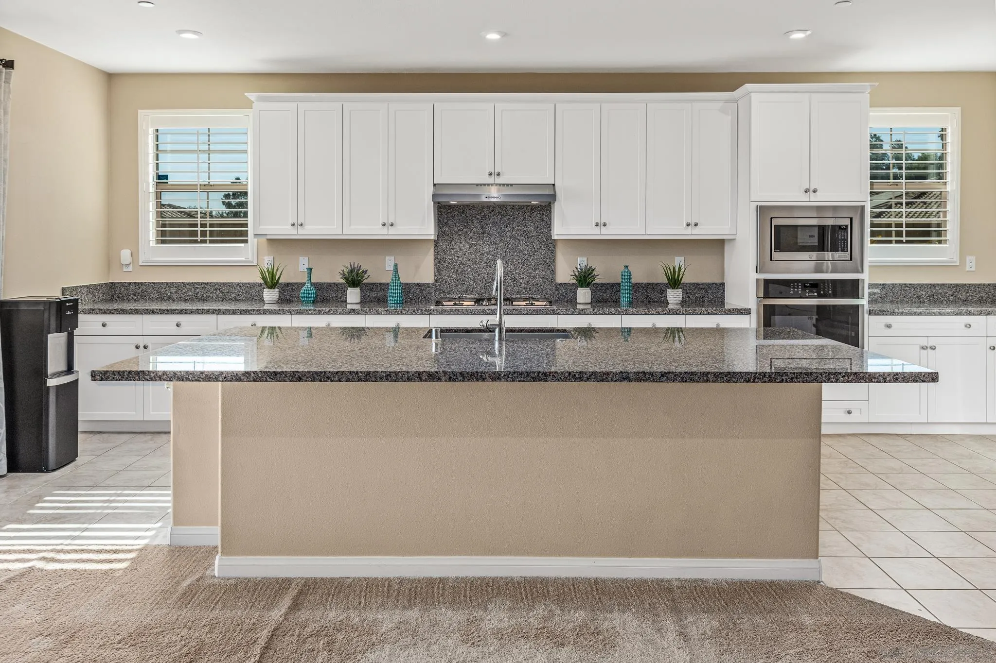 2401 Monroe Place Escondido, CA 92027 - Photo 6 of 23 a kitchen with stainless steel appliances granite countertop a stove a sink and white cabinets