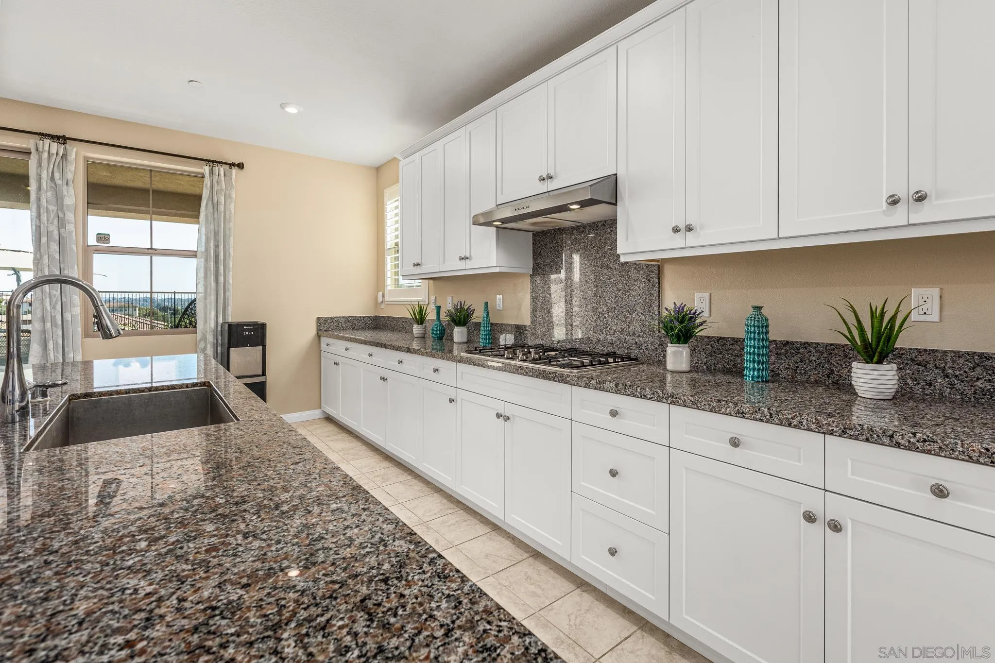 2401 Monroe Place Escondido, CA 92027 - Photo 8 of 23 a kitchen with granite countertop white cabinets and white appliances