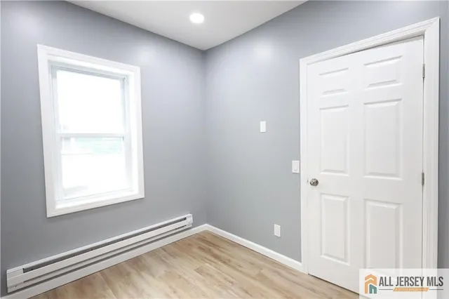 an empty room with windows and closet