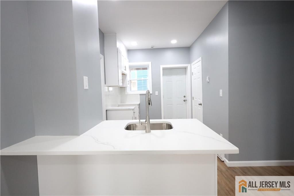 397 Washington Street Perth Amboy, NJ 08861 - Photo 6 of 8 a bathroom with a sink and a mirror