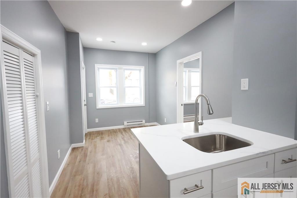 397 Washington Street Perth Amboy, NJ 08861 - Photo 8 of 8 a kitchen with a sink and chandelier