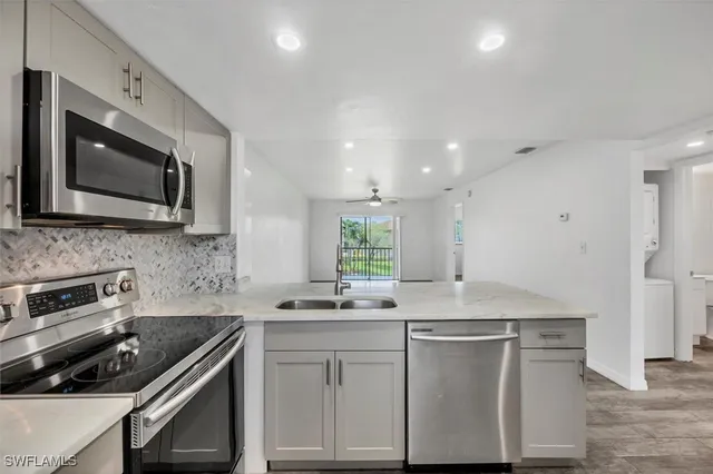 a kitchen with a sink stove and microwave