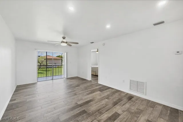 wooden floor in an empty room with a window