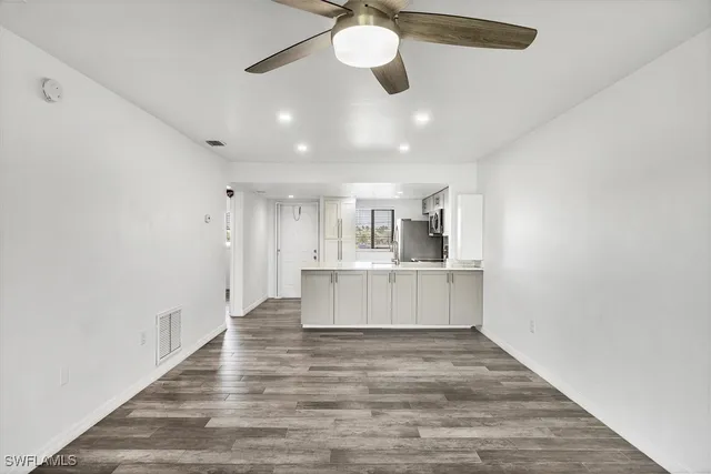 a view of kitchen and kitchen with wooden floor