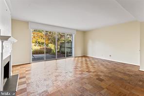 2 Hamlet Hill Road Baltimore, MD 21210 - Photo 12 of 25 an empty room with floor to ceiling window and an outdoor view