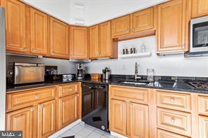2 Hamlet Hill Road Baltimore, MD 21210 - Photo 5 of 25 a kitchen with granite countertop a sink stove top oven and cabinets