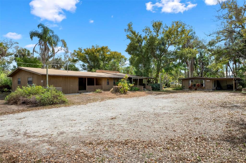 a front view of a house with a yard and trees