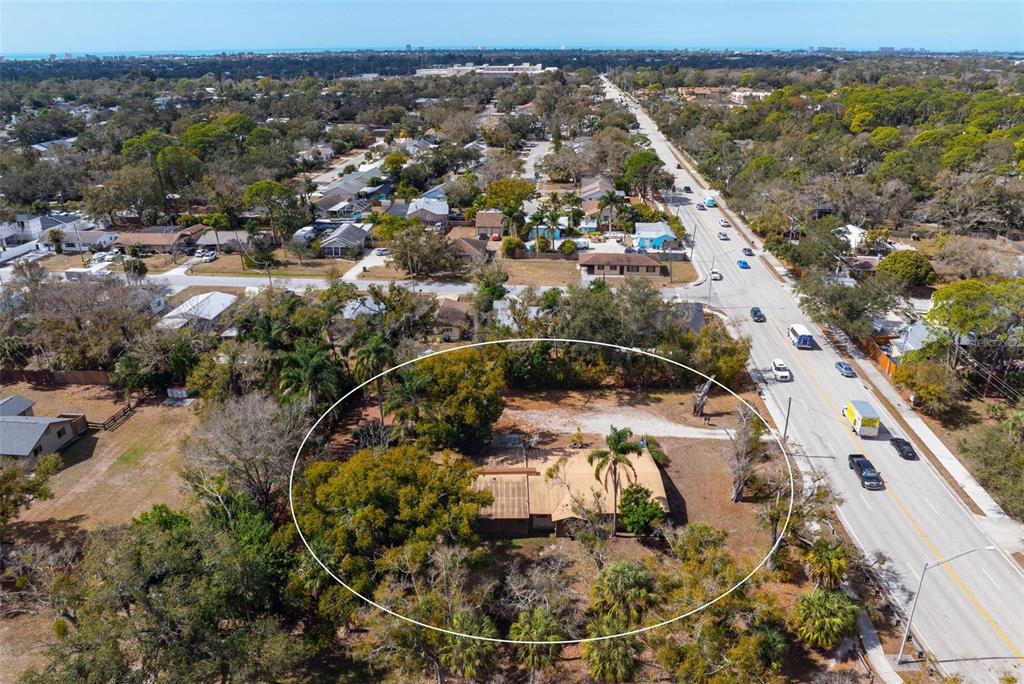 3034 Proctor Road Sarasota, FL 34231 - Photo 16 of 22 an aerial view of a house with a yard and lake view