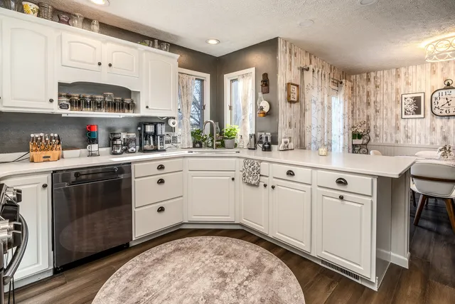 a kitchen with white cabinets sink and white appliances