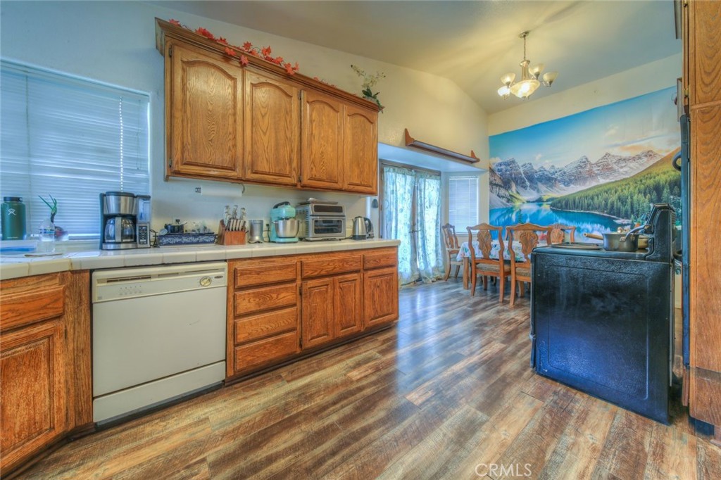 57775 Bailey Road Anza, CA 92539 - Photo 16 of 55 a kitchen with stainless steel appliances granite countertop a sink dishwasher stove and cabinets with wooden floor