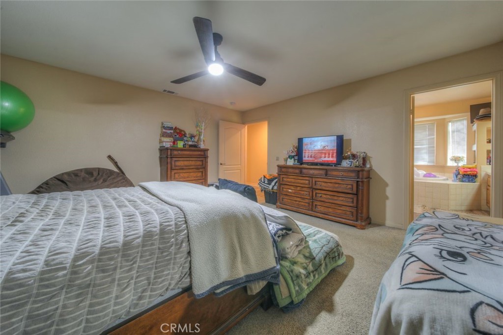 57775 Bailey Road Anza, CA 92539 - Photo 32 of 55 a bedroom with a bed and a chandelier