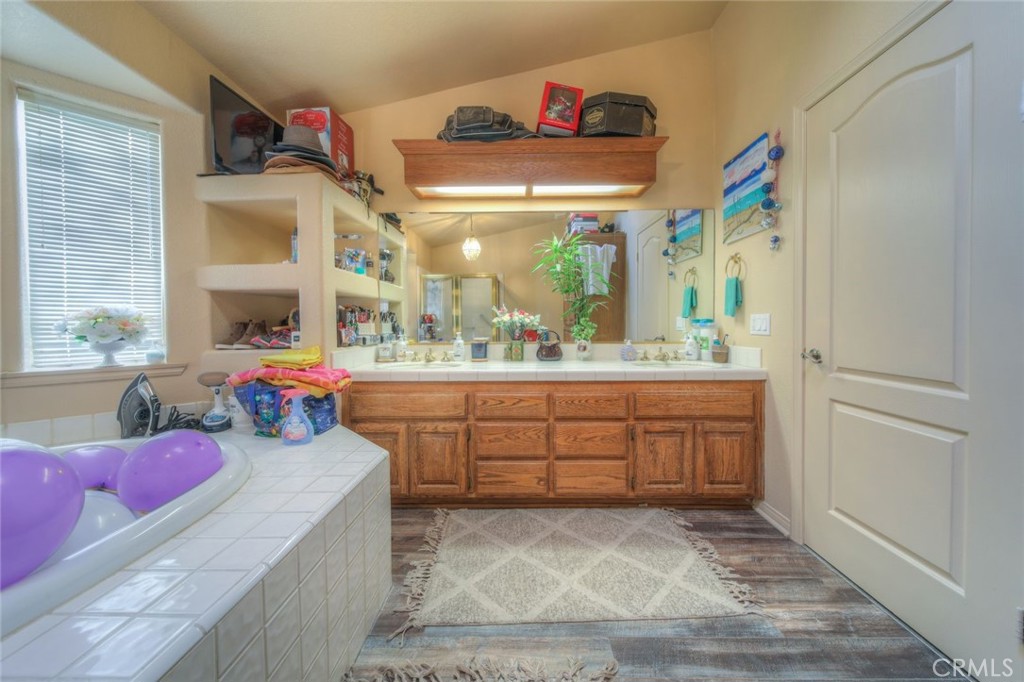 57775 Bailey Road Anza, CA 92539 - Photo 35 of 55 a spacious bathroom with a granite countertop sink and a large mirror